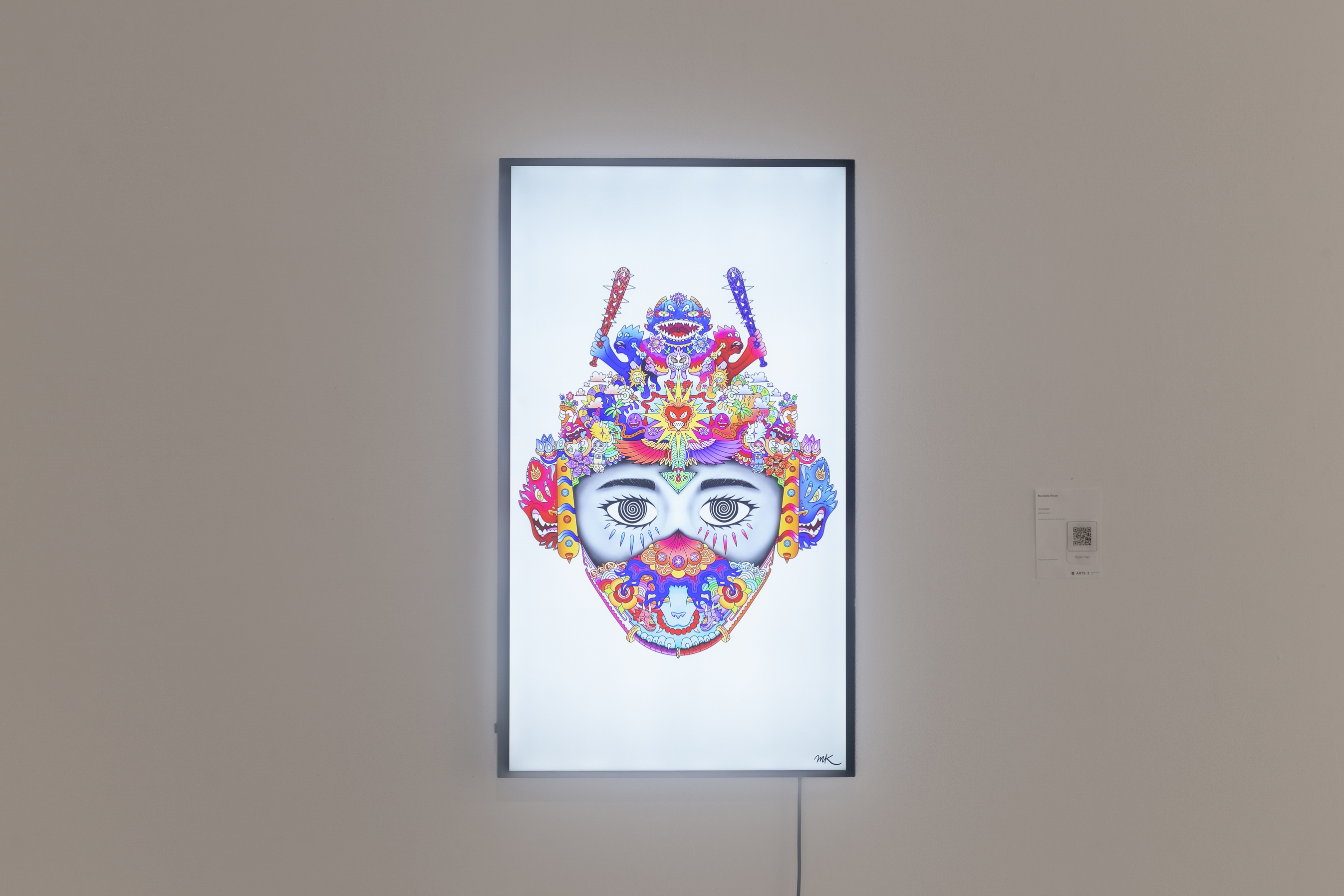 A TV that is hung on the wall that displays a colorful illustration of a person's face with various abstractions.